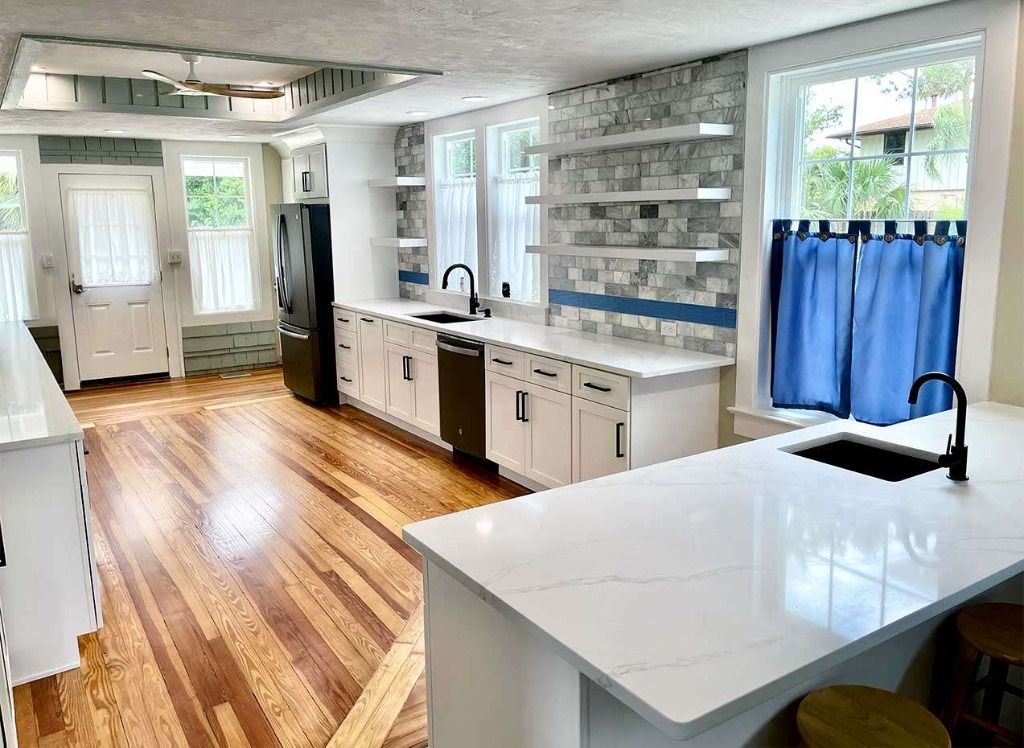 Bright Transitional Kitchen Remodel with Sage Island and Brass Hardware