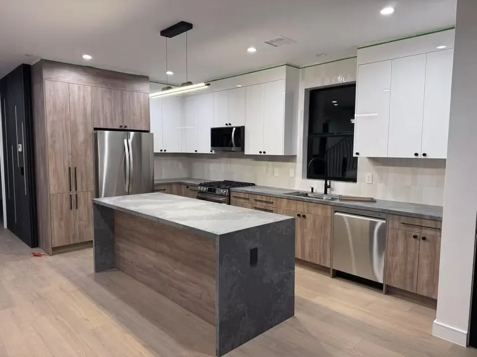 Contemporary kitchen remodel with brass fixtures and custom white cabinets