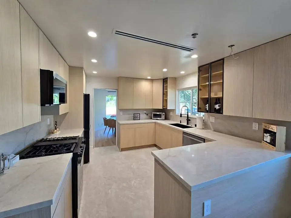 Spacious kitchen island with quartz countertop and gold faucet in Los Angeles